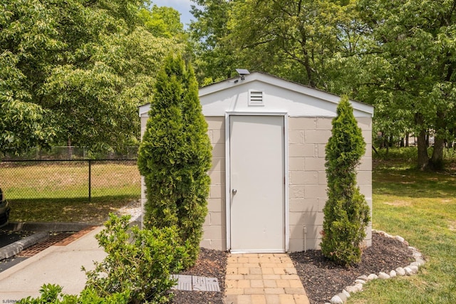 view of outbuilding with a lawn