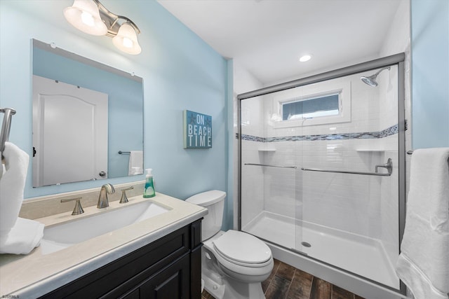 bathroom featuring hardwood / wood-style flooring, vanity, toilet, and an enclosed shower