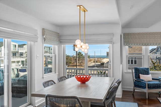 dining area featuring dark hardwood / wood-style floors and an inviting chandelier