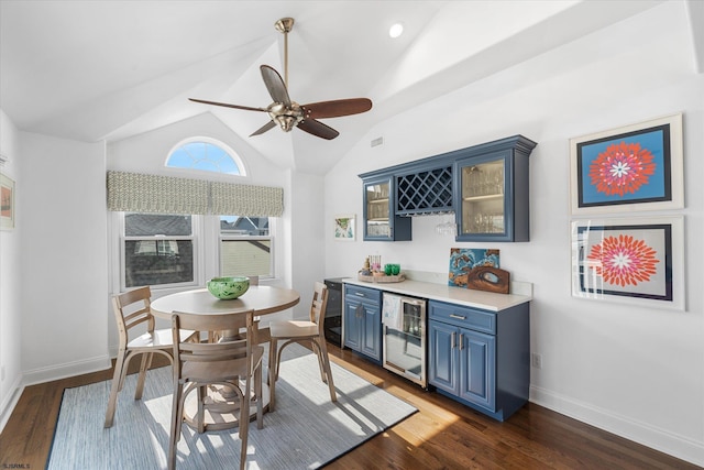 dining area with vaulted ceiling, dark hardwood / wood-style floors, bar, and wine cooler