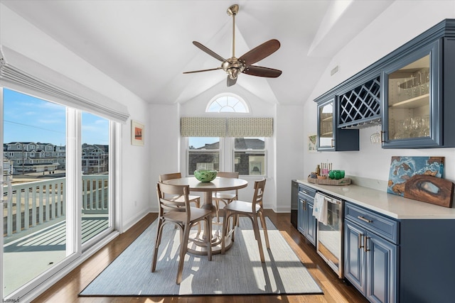 kitchen with blue cabinets, lofted ceiling, dark hardwood / wood-style floors, and ceiling fan