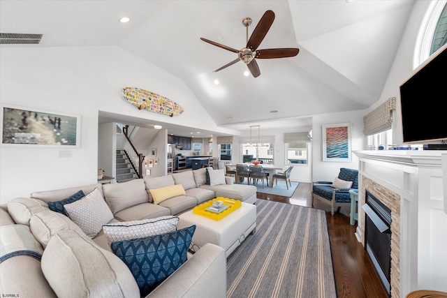 living room with dark hardwood / wood-style flooring, high vaulted ceiling, and ceiling fan