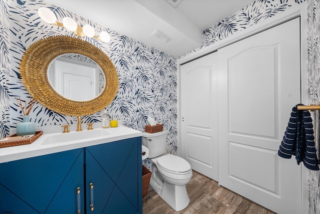 bathroom with vanity, wood-type flooring, and toilet