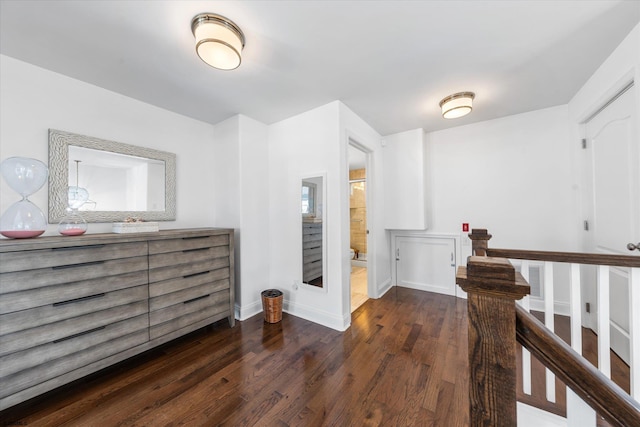 corridor with dark hardwood / wood-style floors