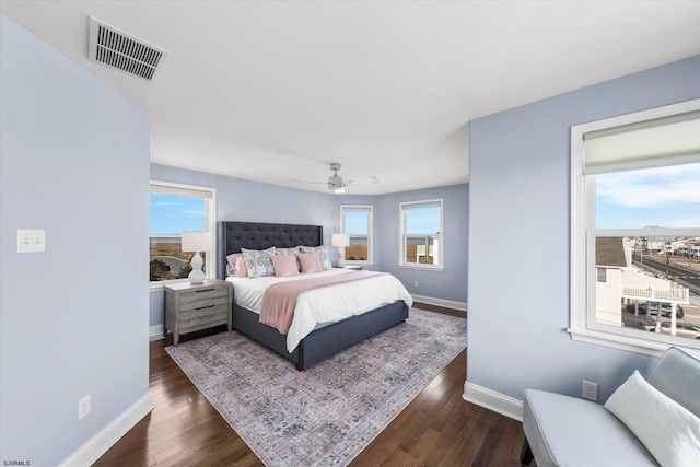 bedroom with dark hardwood / wood-style floors and ceiling fan