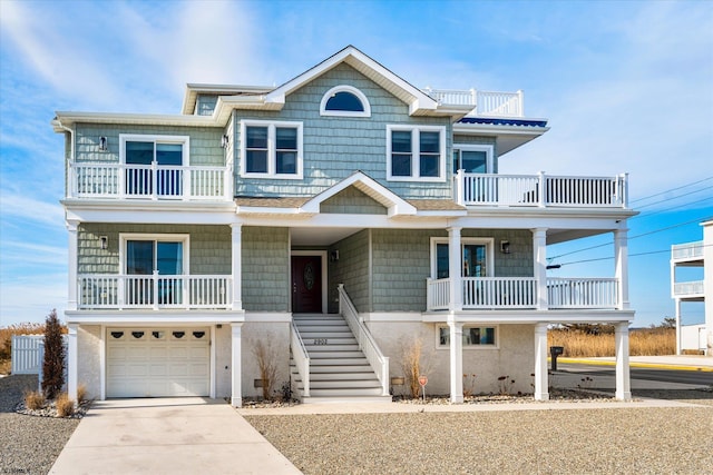 raised beach house with a garage and a balcony