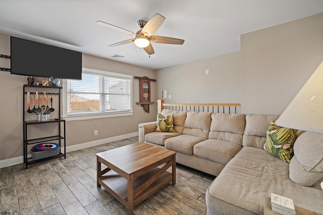 living room with ceiling fan and wood-type flooring