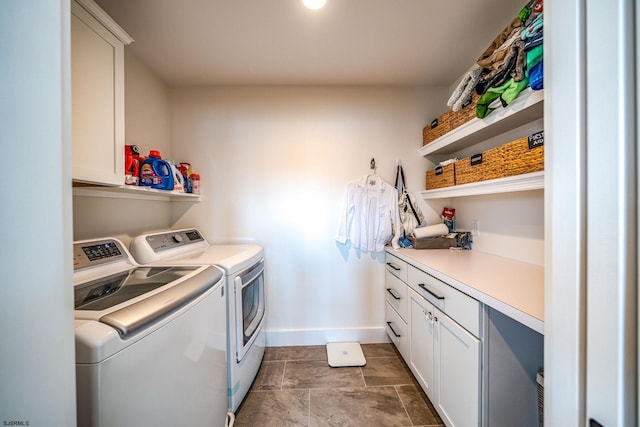 laundry area with cabinets and washing machine and clothes dryer