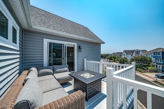 wooden deck featuring an outdoor living space with a fire pit