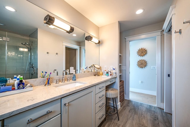 bathroom featuring vanity, hardwood / wood-style flooring, and a shower with shower door