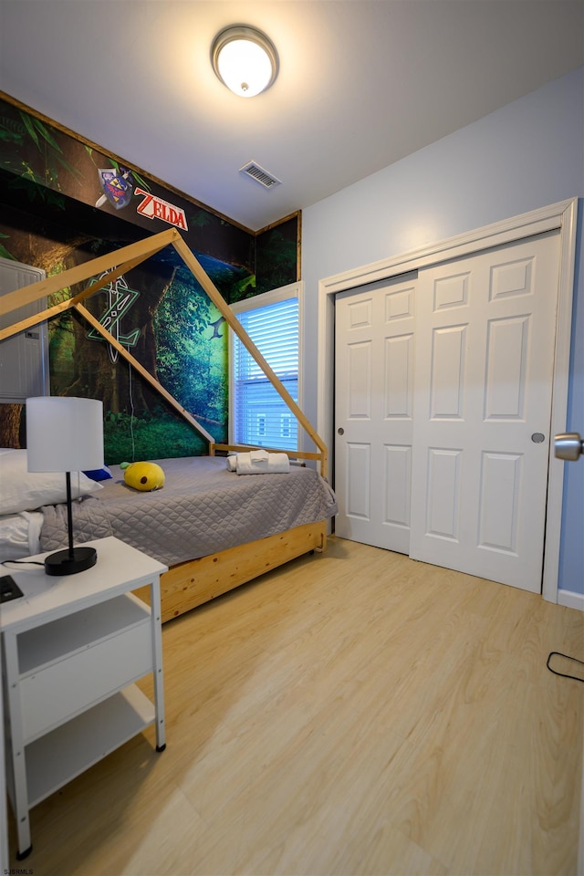 bedroom featuring hardwood / wood-style floors and a closet