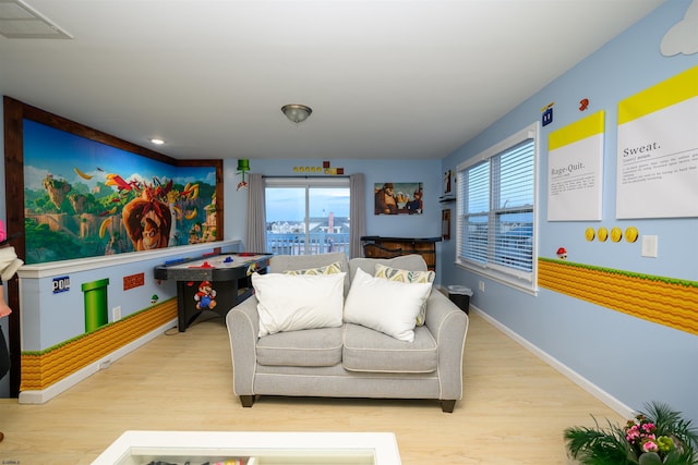 living room featuring plenty of natural light and light hardwood / wood-style floors