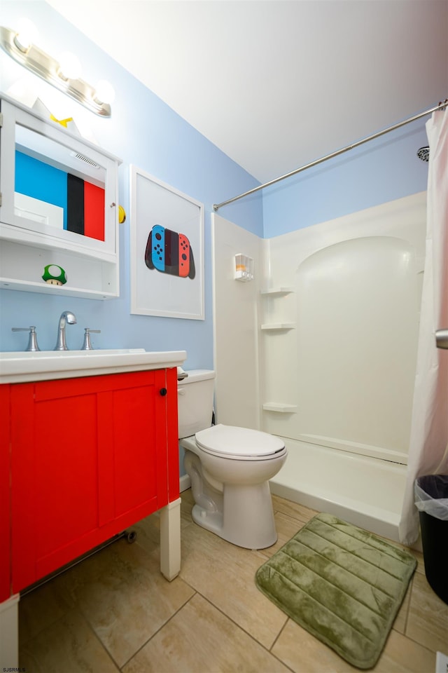 bathroom featuring vanity, tile patterned floors, toilet, and a shower with shower curtain