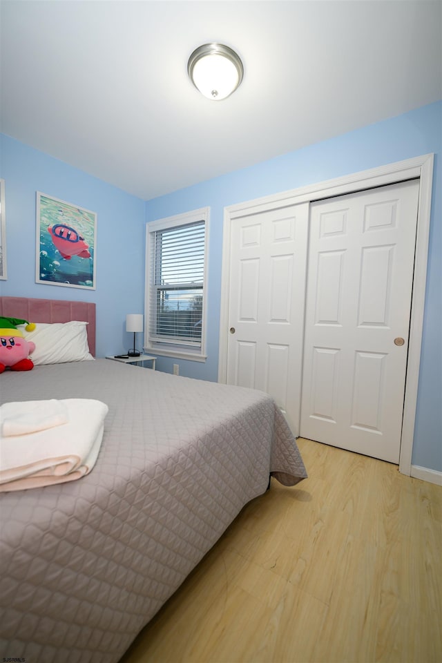 bedroom featuring a closet and light hardwood / wood-style flooring