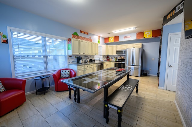 kitchen with sink, backsplash, and appliances with stainless steel finishes