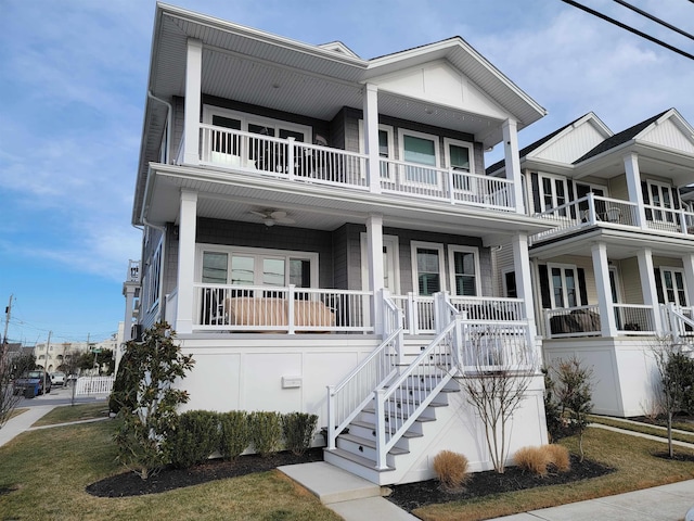 view of front of house featuring stairs, a porch, and a balcony