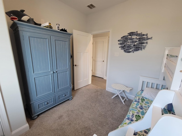 bedroom with light colored carpet, visible vents, and baseboards