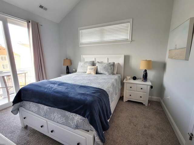 bedroom featuring carpet flooring, vaulted ceiling, and multiple windows