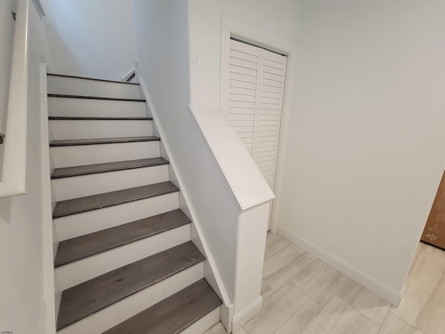 stairway featuring baseboards