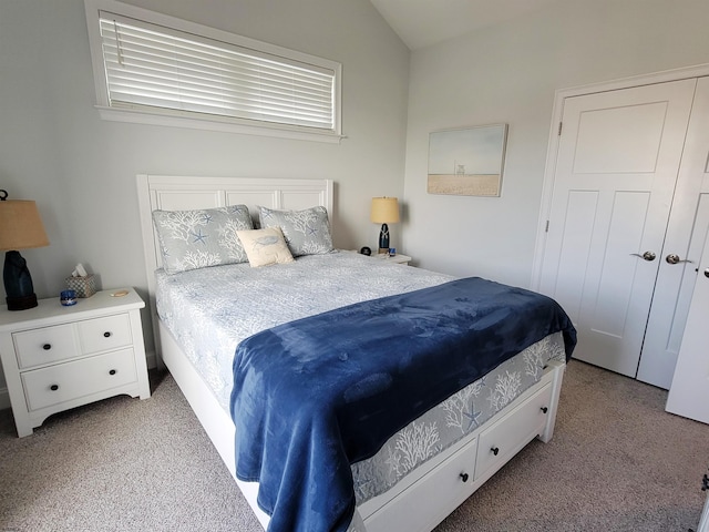 bedroom featuring light carpet and vaulted ceiling