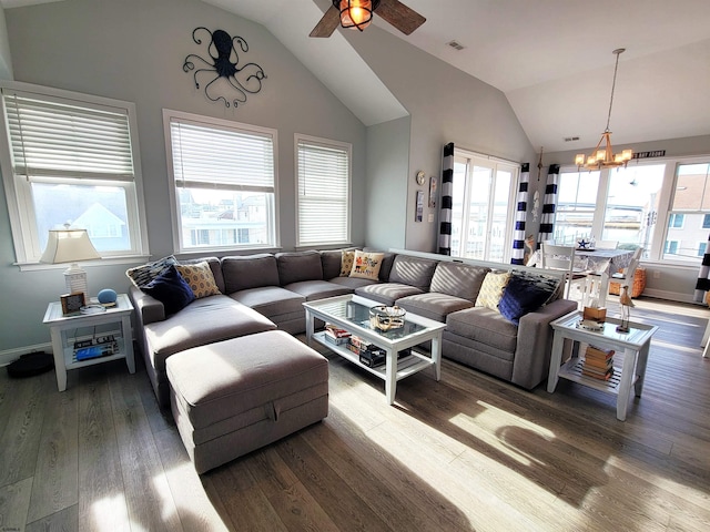 living room featuring lofted ceiling, visible vents, plenty of natural light, and wood finished floors