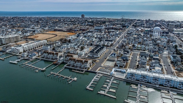 birds eye view of property featuring a water view and a city view