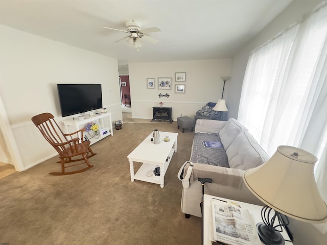 living room featuring dark carpet and ceiling fan