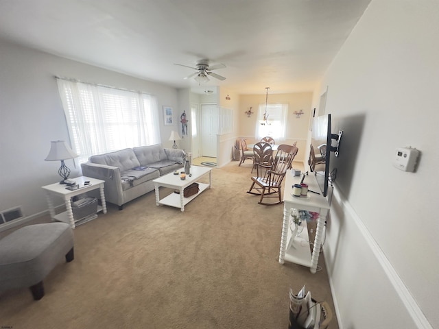 carpeted living room featuring a wealth of natural light and ceiling fan