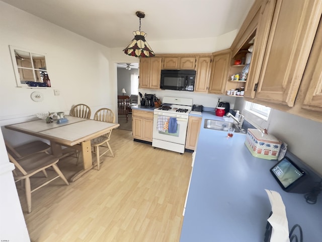 kitchen with pendant lighting, sink, light brown cabinetry, white gas range, and light wood-type flooring