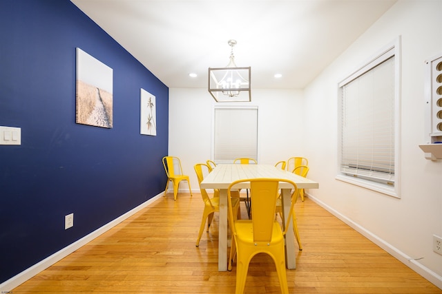 dining room with a chandelier and light wood-type flooring