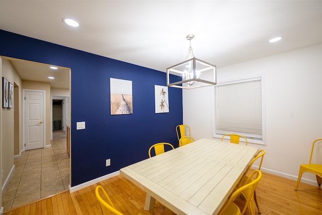 dining area featuring a chandelier and light wood-type flooring