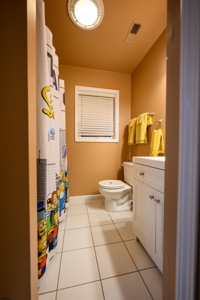 bathroom with vanity, toilet, and tile patterned flooring