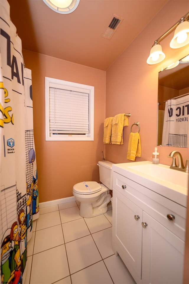 bathroom featuring vanity, toilet, and tile patterned flooring