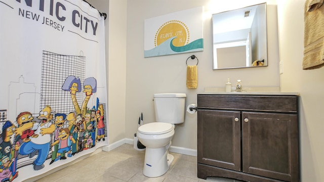 bathroom with tile patterned flooring, vanity, and toilet