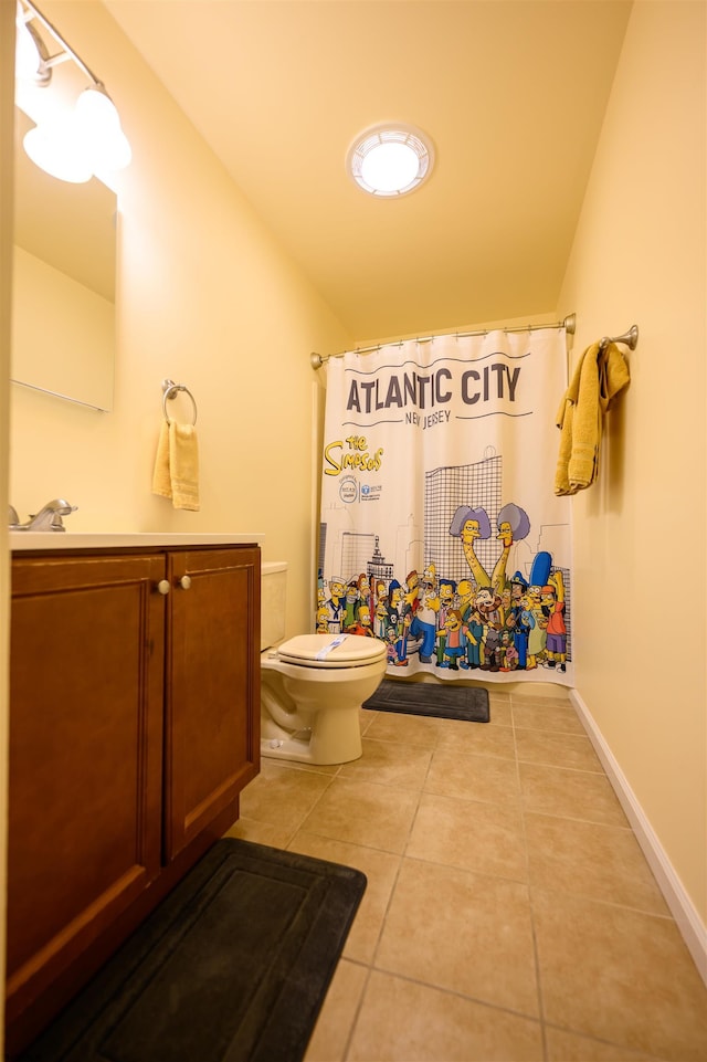 bathroom featuring lofted ceiling, vanity, toilet, tile patterned floors, and a shower with curtain