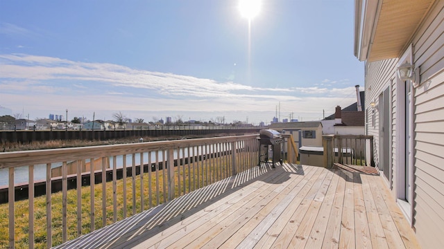 wooden terrace with a grill