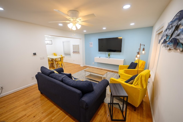 living room featuring ceiling fan and light wood-type flooring