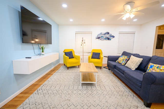 living room with wood-type flooring and ceiling fan