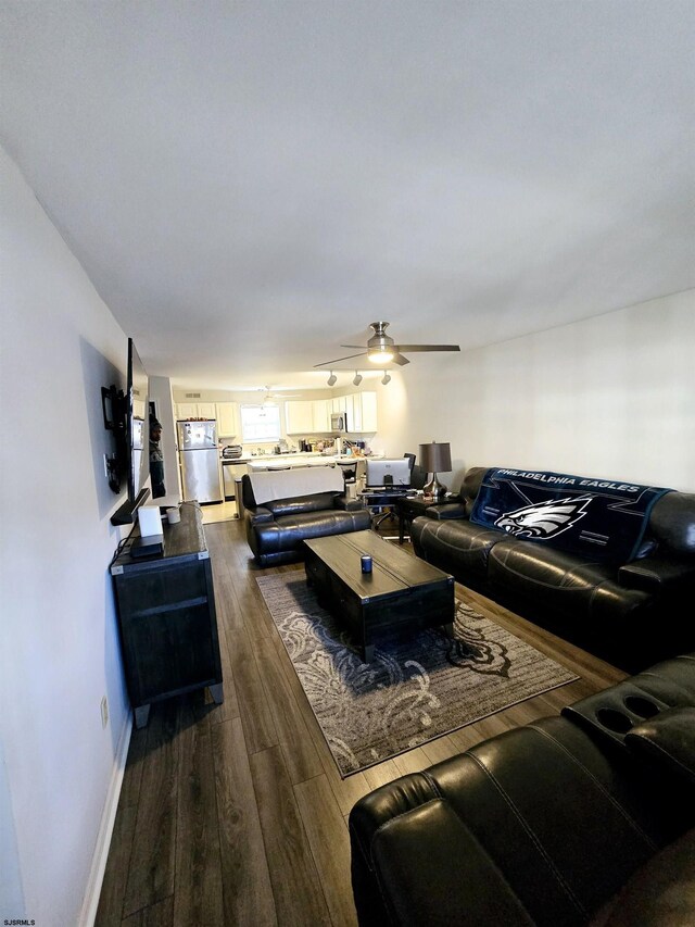 living room featuring hardwood / wood-style floors and ceiling fan