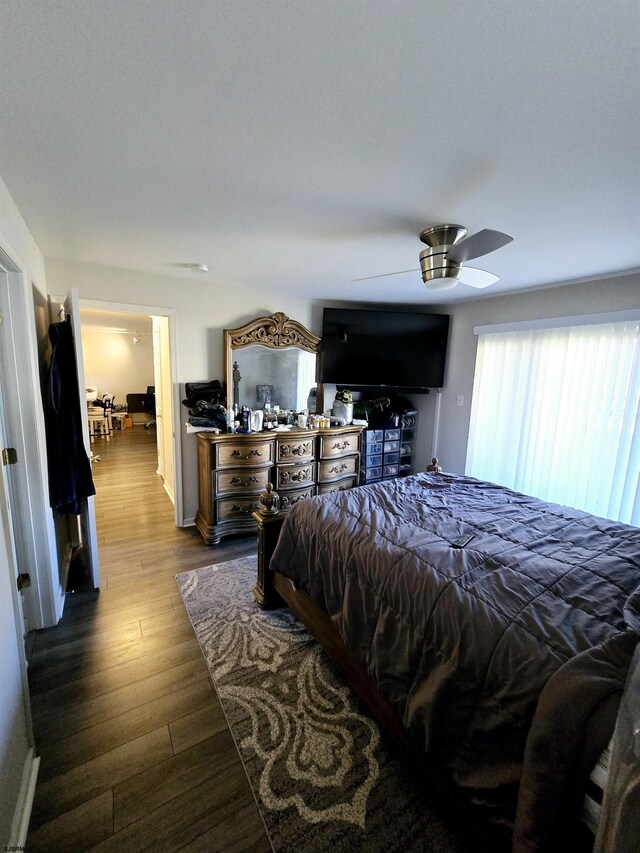 bedroom featuring dark wood-type flooring and ceiling fan