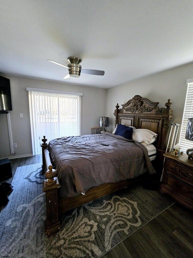 bedroom with dark hardwood / wood-style floors and ceiling fan