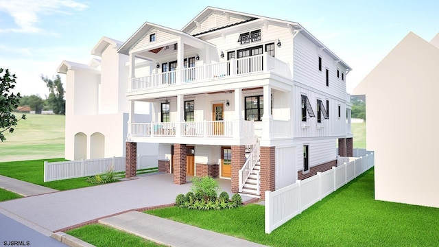 view of front of home featuring a porch, a balcony, and a front yard