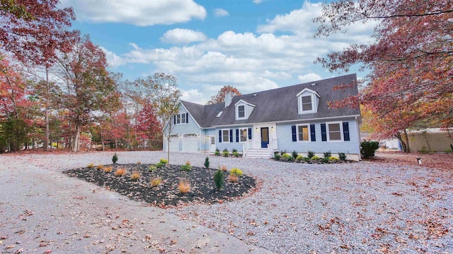 new england style home featuring a garage