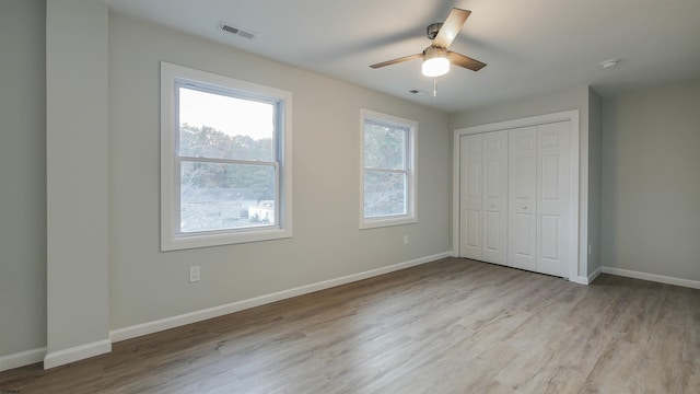 unfurnished bedroom featuring a closet, ceiling fan, and light wood-type flooring