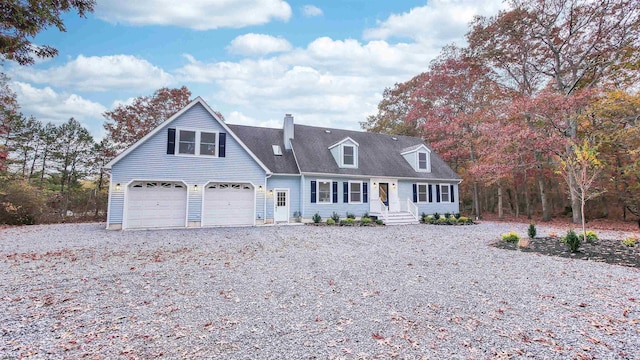 new england style home with a garage