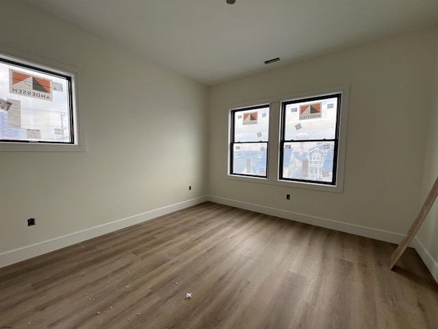 empty room with hardwood / wood-style flooring