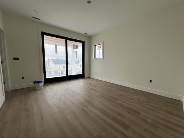 empty room featuring dark wood-type flooring