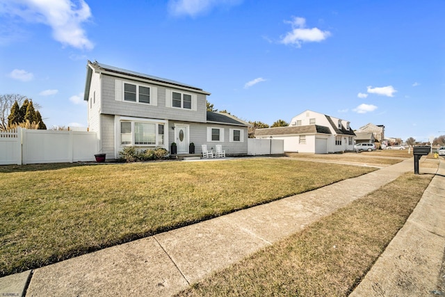 view of property with a patio and a front lawn