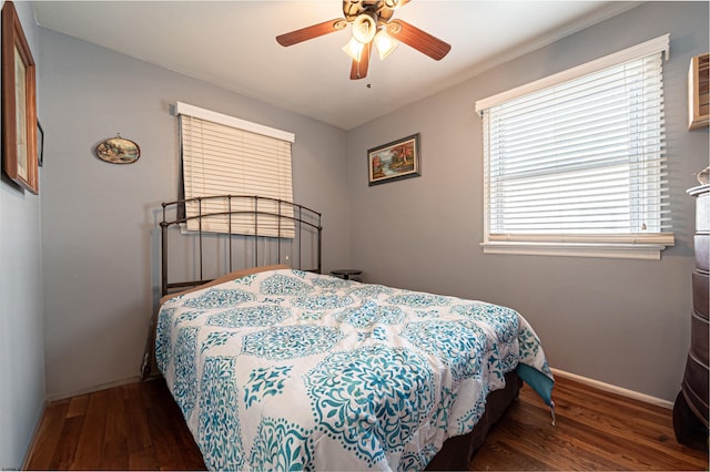 bedroom with dark hardwood / wood-style floors and ceiling fan