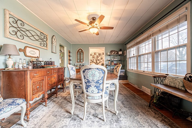 dining space with hardwood / wood-style flooring and ceiling fan